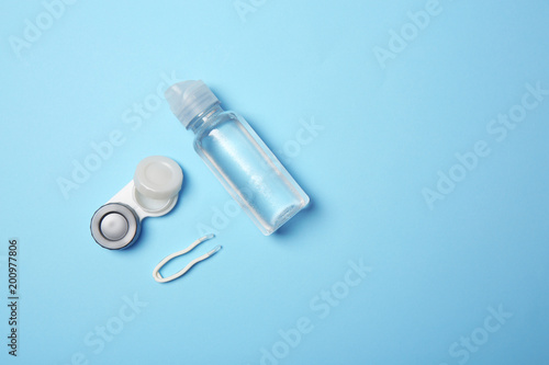 Flat lay composition with contact lens accessories on color background