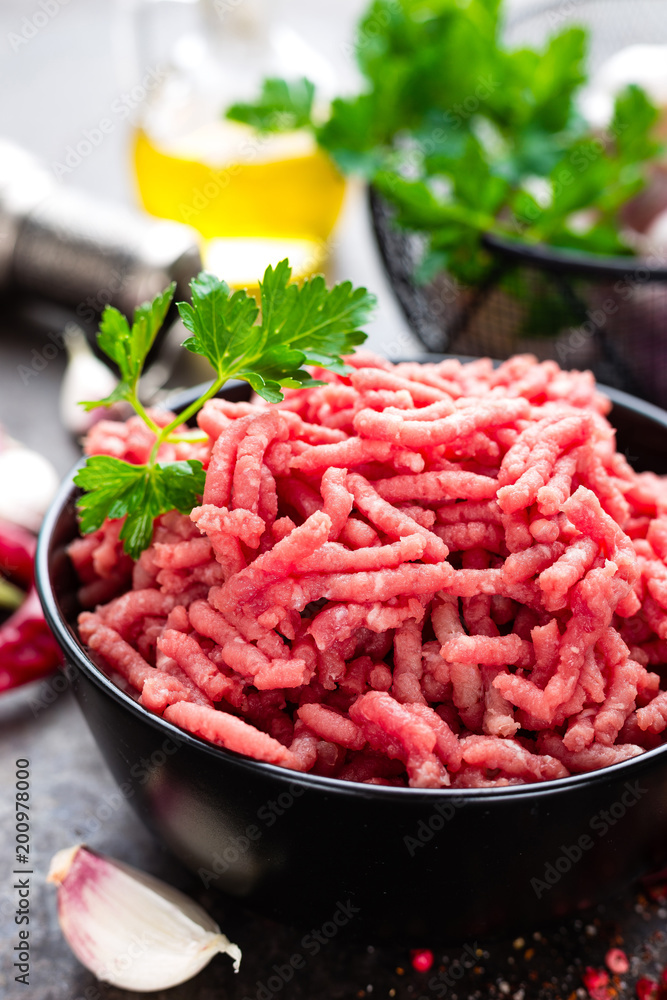 Raw ground beef meat with ingredients for cooking. Fresh minced meat