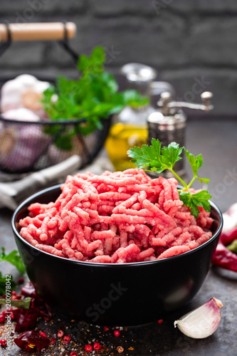 Raw ground beef meat with ingredients for cooking. Fresh minced meat