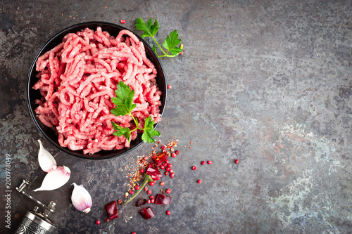 Raw ground beef meat with ingredients for cooking. Fresh minced meat