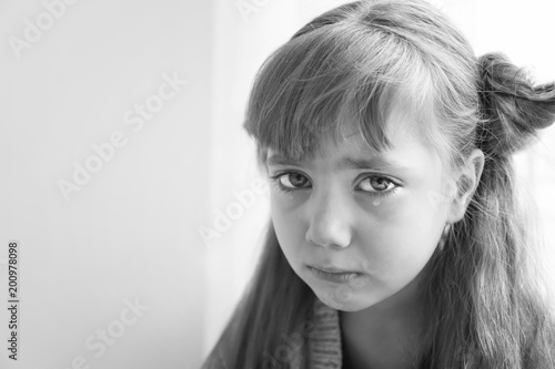Portrait of sad little girl, black and white effect photo