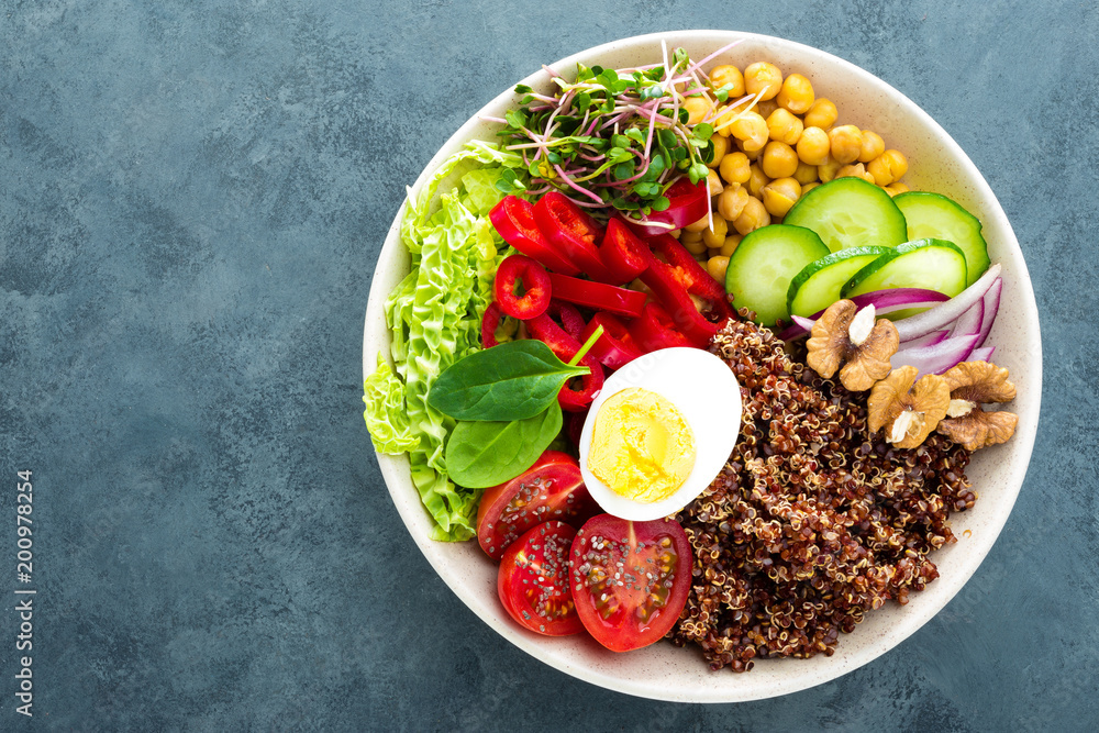 Buddha bowl dish with boiled egg, chickpea, fresh tomato, sweet pepper, cucumber, savoy cabbage, red onion, green sprouts, spinach leaves, chia and quinoa Buddha bowl dish with boiled egg, chickpea, fresh tomato, sweet pepper, cucumber, savoy cabbage, red onion, green sprouts, spinach leaves, chia and quinoa