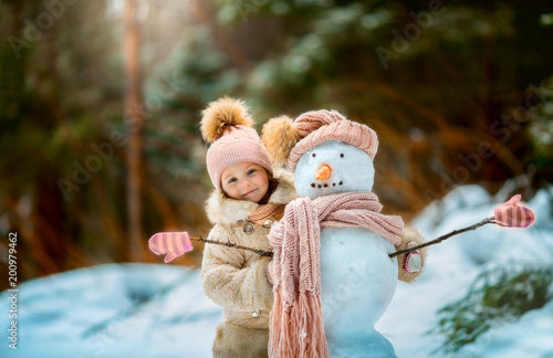 4065027 Little girl with snowman