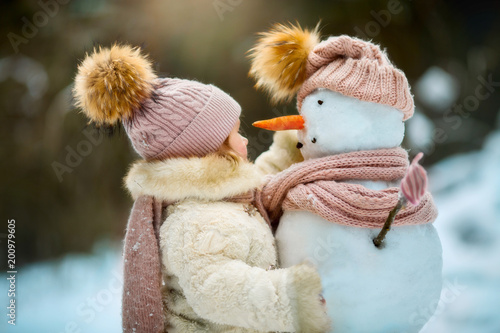 4065034 Little girl with snowman