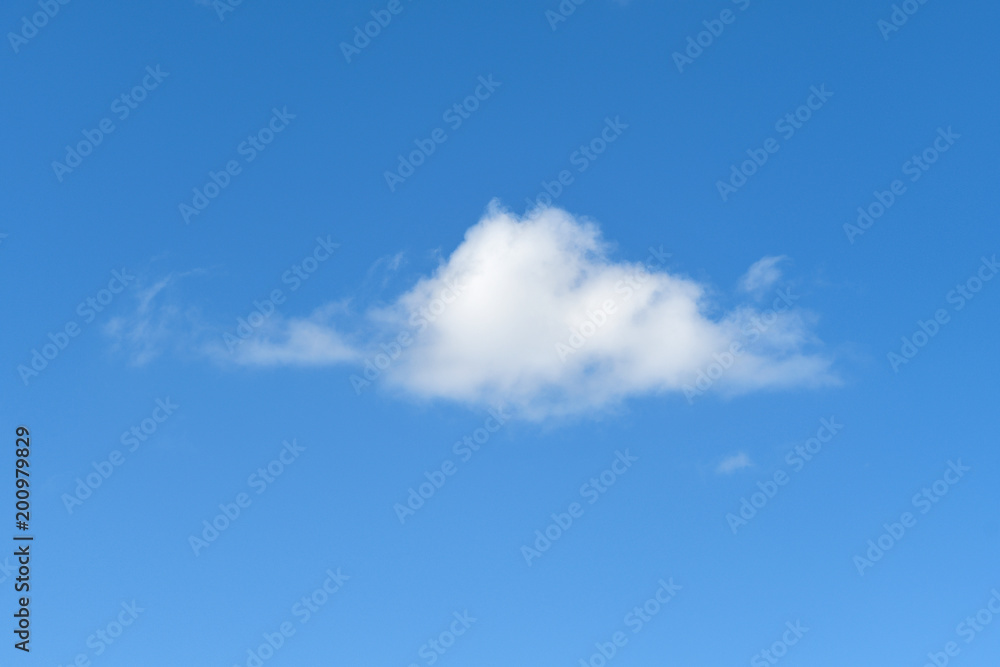 single fluffy white cloud in bright blue sky single fluffy white cloud in bright blue sky