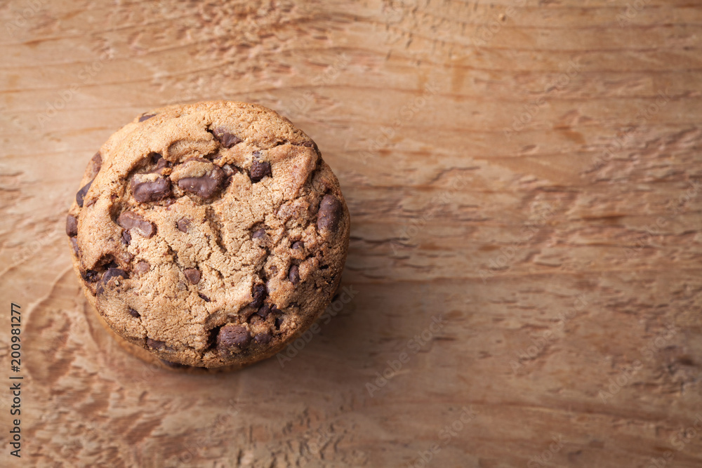 Fototapeta premium Cookies with chocolate chips on a wooden table. Top view with copy space