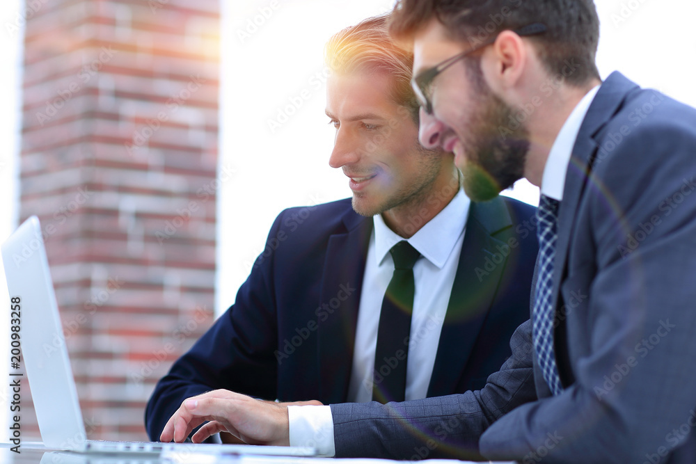 Male executives in office, looking at computer Male executives in office, looking at computer