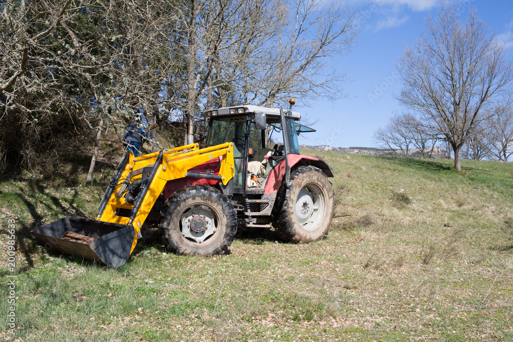 A tractor used in the field of tillage A tractor used in the field of tillage