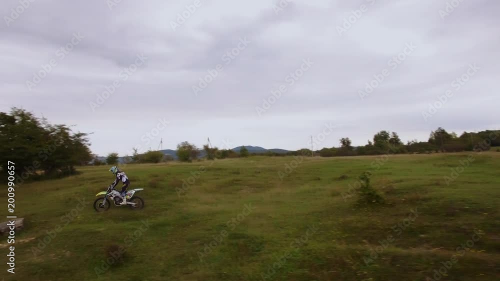 Off-road motorbike rides on a nature aerial view 4k Off-road motorbike rides on a nature aerial view 4k