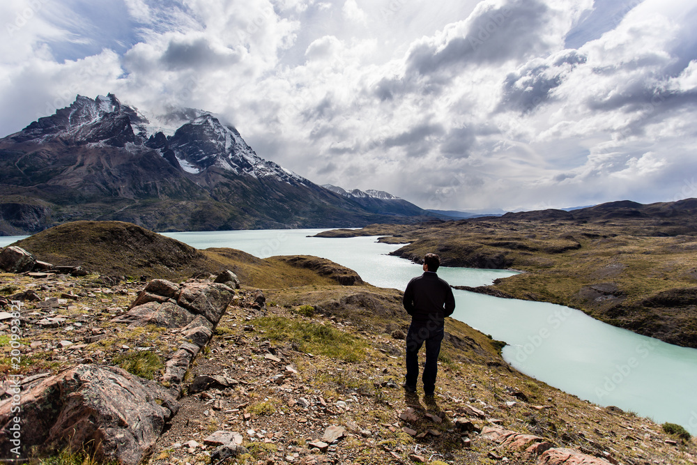 man looking toward awesome view of Torres del Paine mountain range