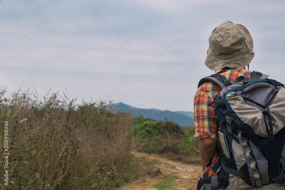 Young man trekker enjoy traveling with backpack, hiking concept, travel concept Young man trekker enjoy traveling with backpack, hiking concept, travel concept