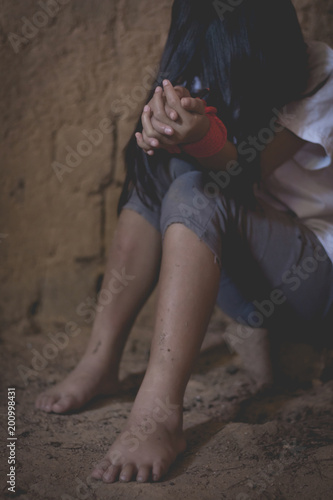 Domestic and sexual violence ,sad little girl hands with rope imprisoned in old room ,trafficking concept.rape and violence,