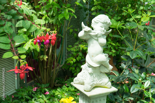 Figurine of an angel playing the flute in the garden