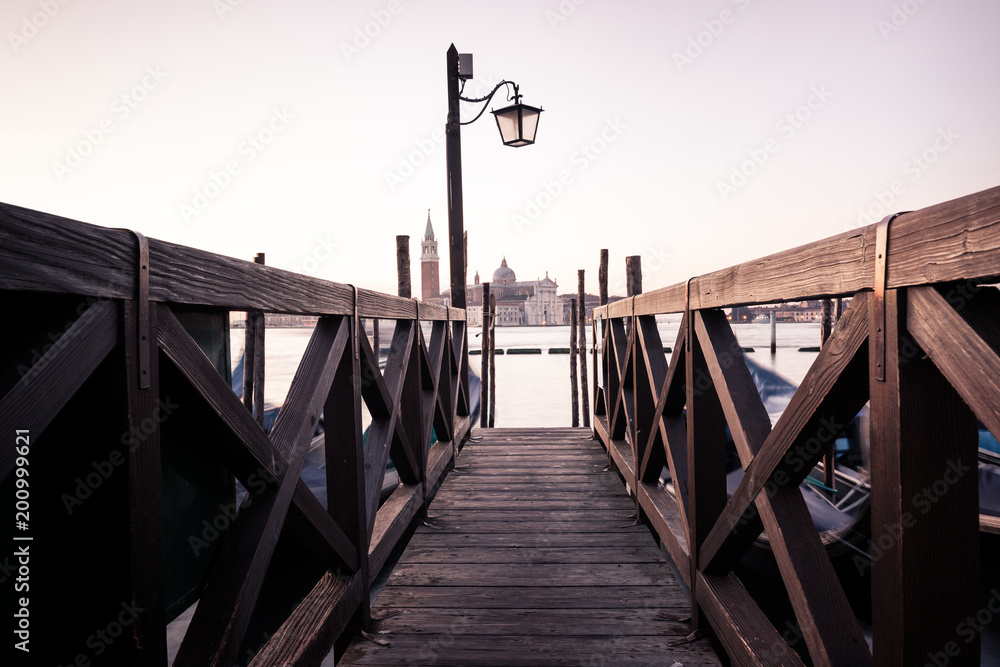 Venice classic view with famous gondolas at sunrise, Italy