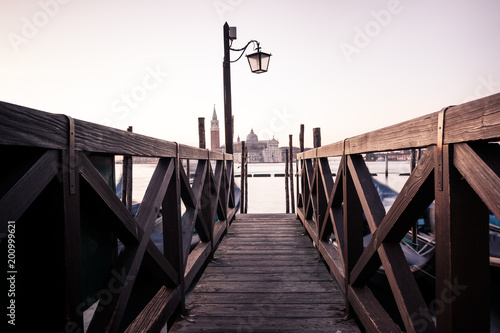 Venice classic view with famous gondolas at sunrise, Italy