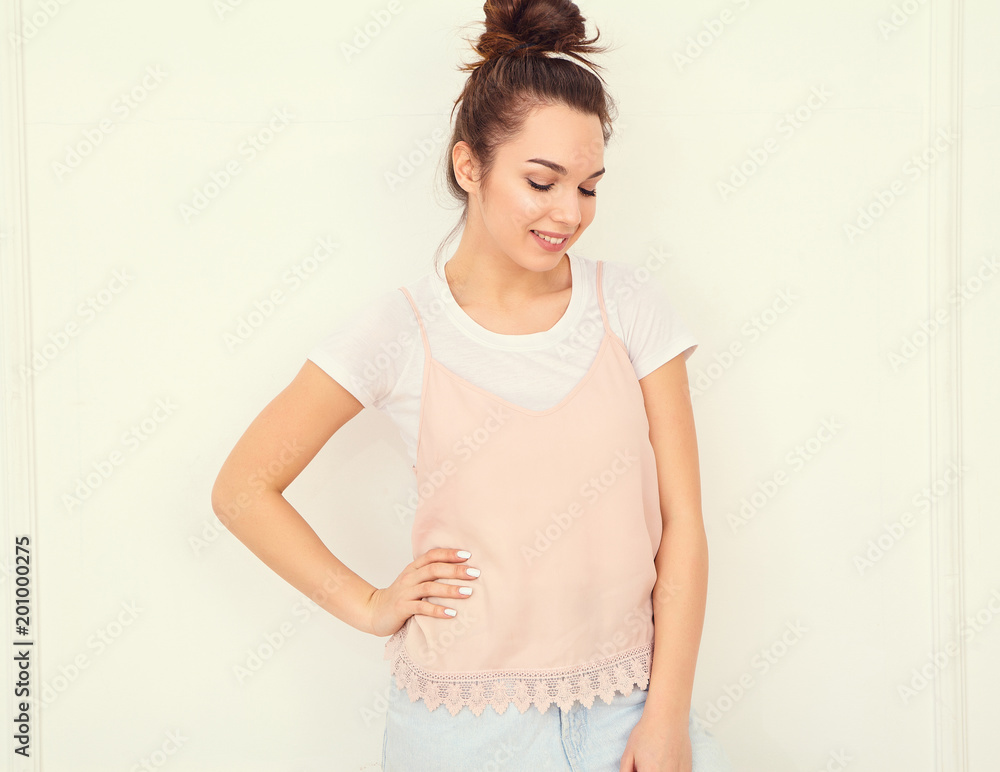 Portrait of young beautiful brunette woman girl model with nude makeup in colorful summer pink hipster clothes posing near wall. Going crazy Portrait of young beautiful brunette woman girl model with nude makeup in colorful summer pink hipster clothes posing near wall. Going crazy