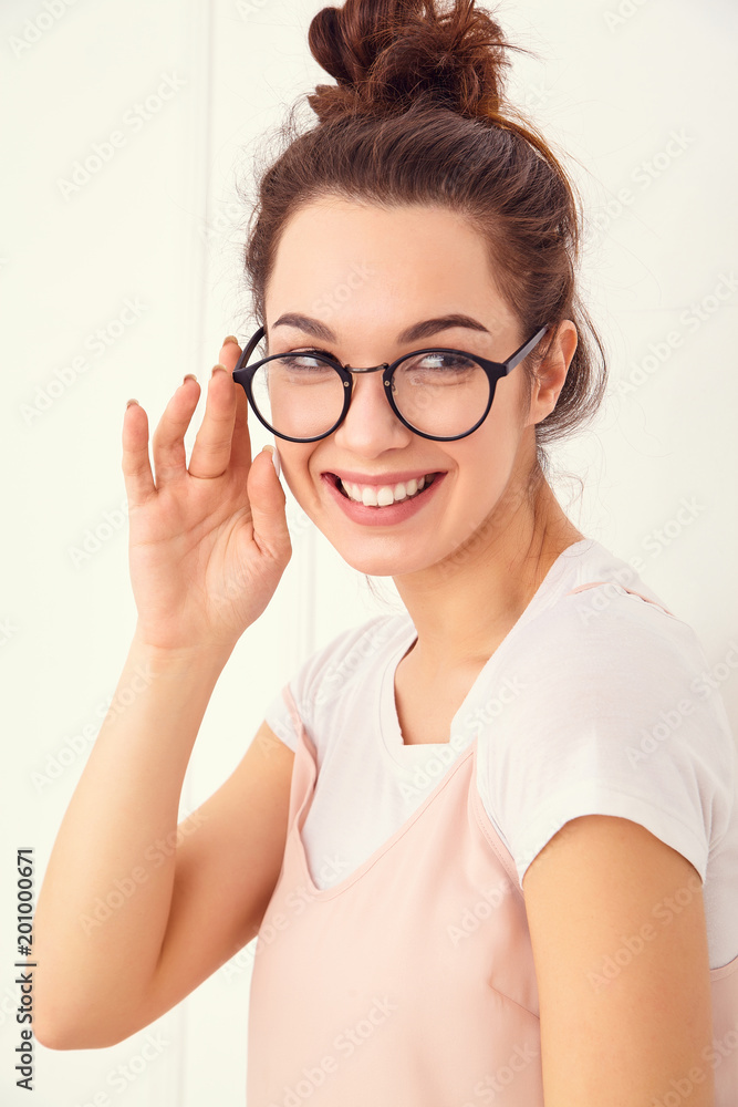 Portrait of young beautiful brunette woman girl model with nude makeup in colorful summer pink hipster clothes posing near wall. Going crazy Portrait of young beautiful brunette woman girl model with nude makeup in colorful summer pink hipster clothes posing near wall. Going crazy