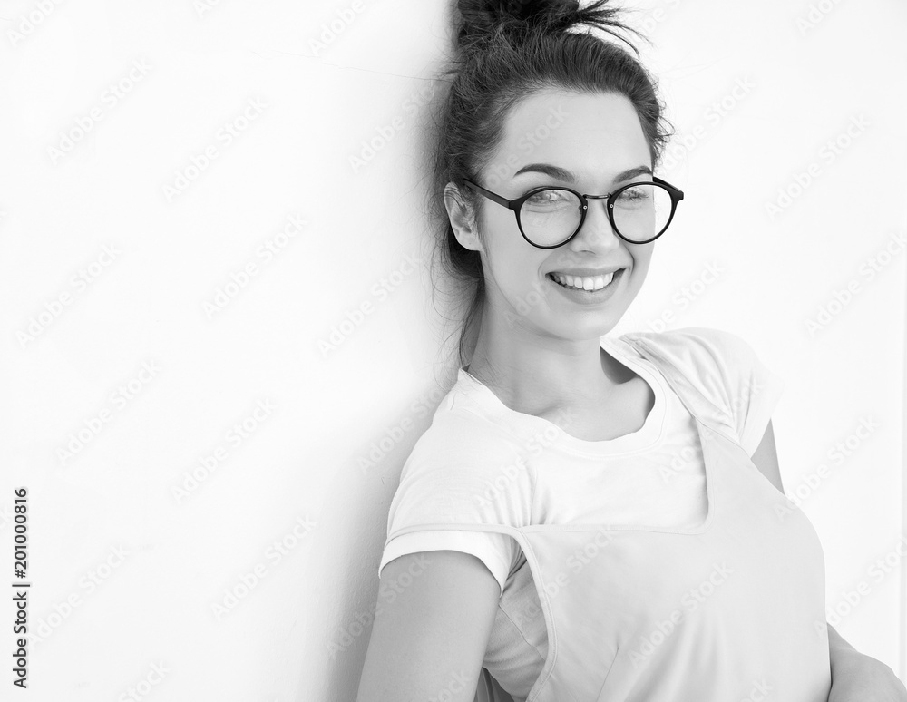 Fototapeta premium Portrait of young beautiful brunette woman girl model with nude makeup in colorful summer pink hipster clothes posing near wall. Going crazy and looking happily in camera