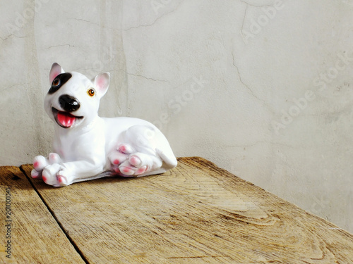 Fototapeta Naklejka Na Ścianę i Meble -  dog statue ceramic with space copy on wooden background