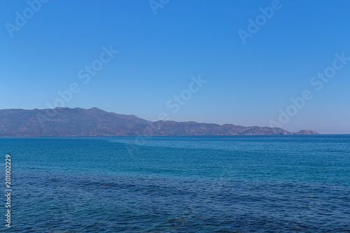 Greek coast, mountains, sea, sky, sun. © zhdanovdi