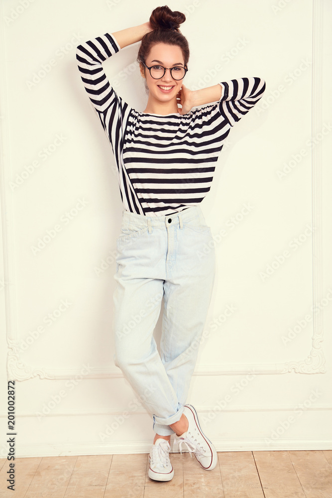 Portrait of young beautiful brunette woman girl model with nude makeup in glasses in summer hipster clothes posing near wall. Going crazy Portrait of young beautiful brunette woman girl model with nude makeup in glasses in summer hipster clothes posing near wall. Going crazy