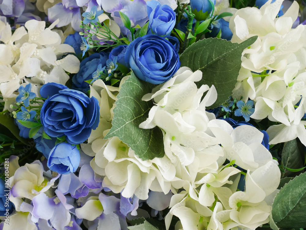Obraz premium Rose fake flower and Floral background. rose flowers made of fabric. The fabric flowers bouquet. Colorful of decoration artificial flower