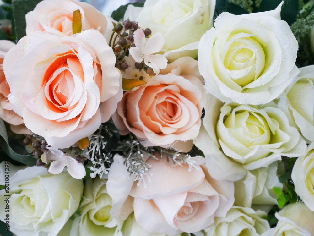 Obraz premium Rose fake flower and Floral background. rose flowers made of fabric. The fabric flowers bouquet. Colorful of decoration artificial flower