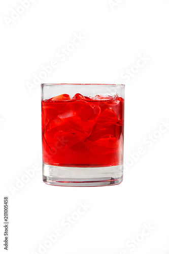 A single-colored transparent cocktail, refreshing in a low glass with ice cubes and taste of berries, cherries, strawberries, greiprut. Side view. Isolated white background. Drink for the menu
