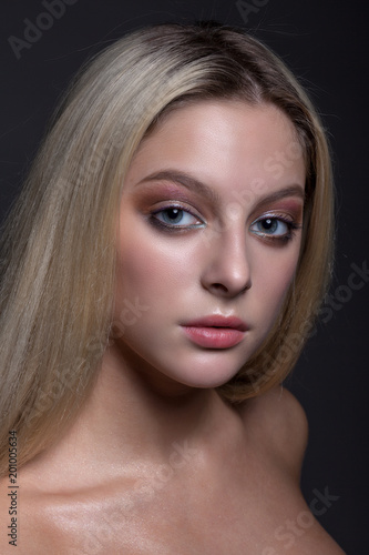 Portrait of a beautiful girl with makeup and hairdress.