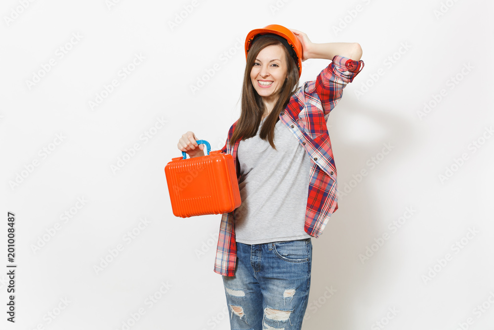Young smiling beautiful woman in casual clothes protective hardhat holding case with instruments or toolbox isolated on white background. Instruments, tools for renovation room. Repair home concept. Young smiling beautiful woman in casual clothes protective hardhat holding case with instruments or toolbox isolated on white background. Instruments, tools for renovation room. Repair home concept.