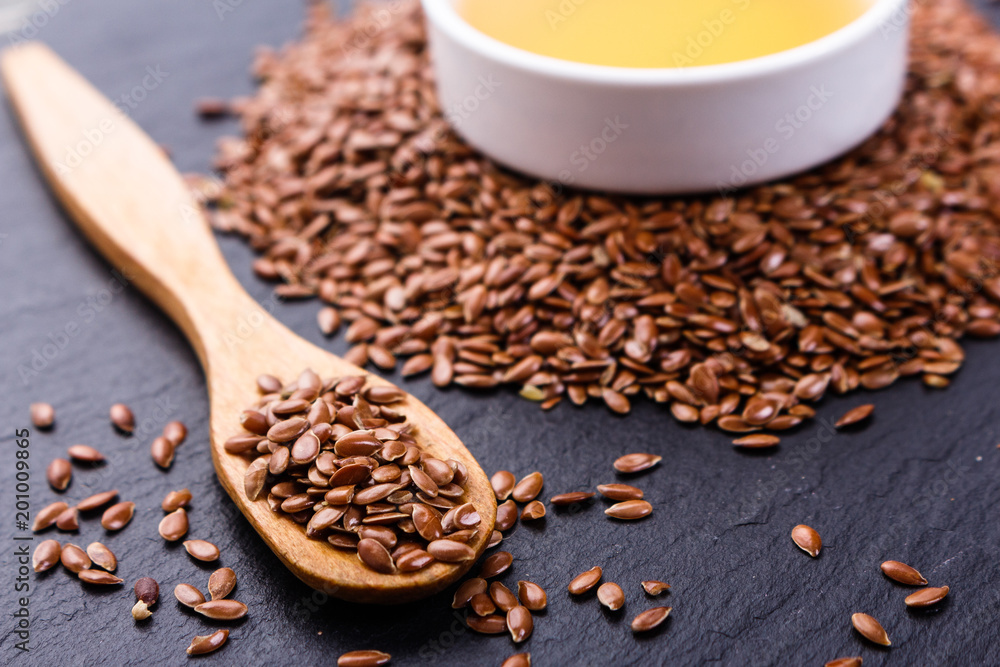 flaxseed and oil on a rustic background flaxseed and oil on a rustic background