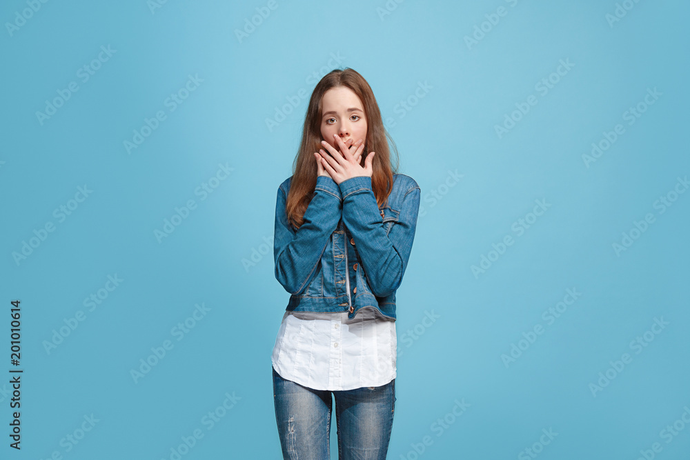 Beautiful teen girl looking suprised isolated on blue Beautiful teen girl looking suprised isolated on blue