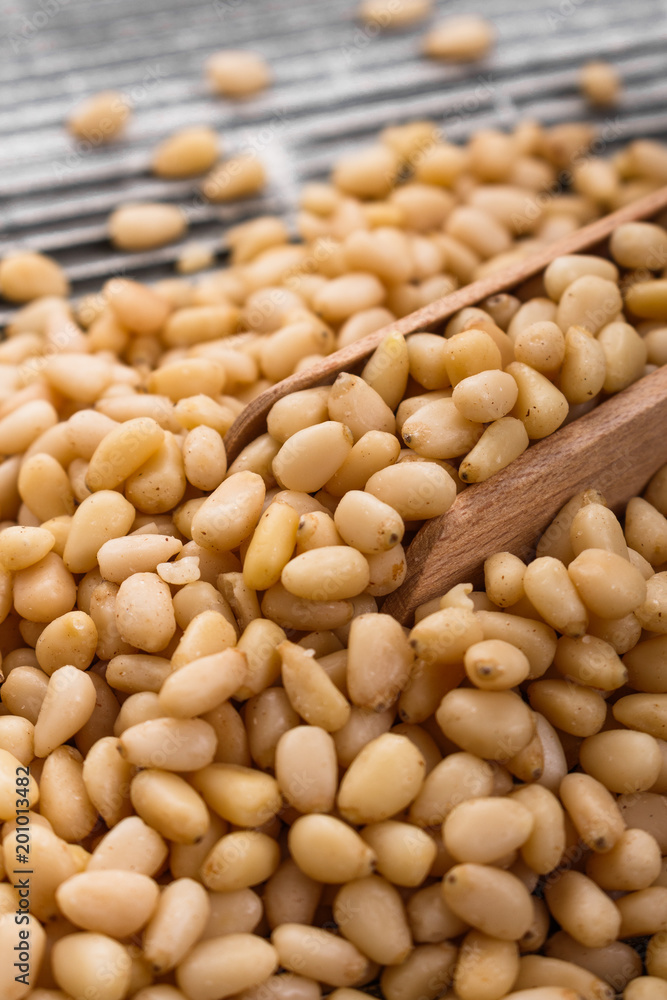 peeled pine nuts on a rustic background peeled pine nuts on a rustic background