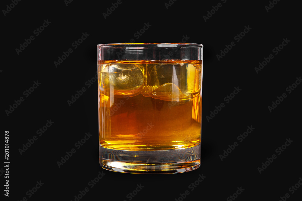 A single-colored transparent cocktail, refreshing in a low glass with radiant ice cubes with a taste of melon, pineapple, pear, apple, fruit. Side view Isolated black background. Drink for the menu