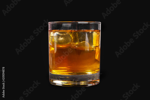 A single-colored transparent cocktail, refreshing in a low glass with radiant ice cubes with a taste of melon, pineapple, pear, apple, fruit. Side view Isolated black background. Drink for the menu