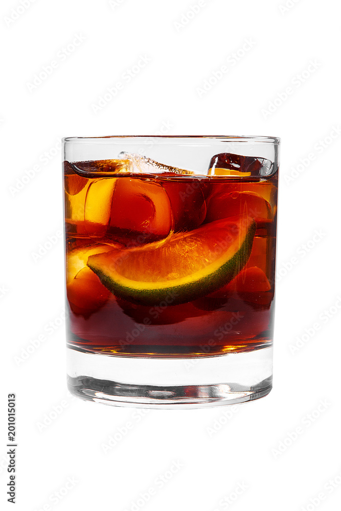 A single-colored transparent cocktail, refreshing in a low glass with radiant ice cubes with taste of berries, cola and slice, lime quartet. Side view Isolated white background A single-colored transparent cocktail, refreshing in a low glass with radiant ice cubes with taste of berries, cola and slice, lime quartet. Side view Isolated white background