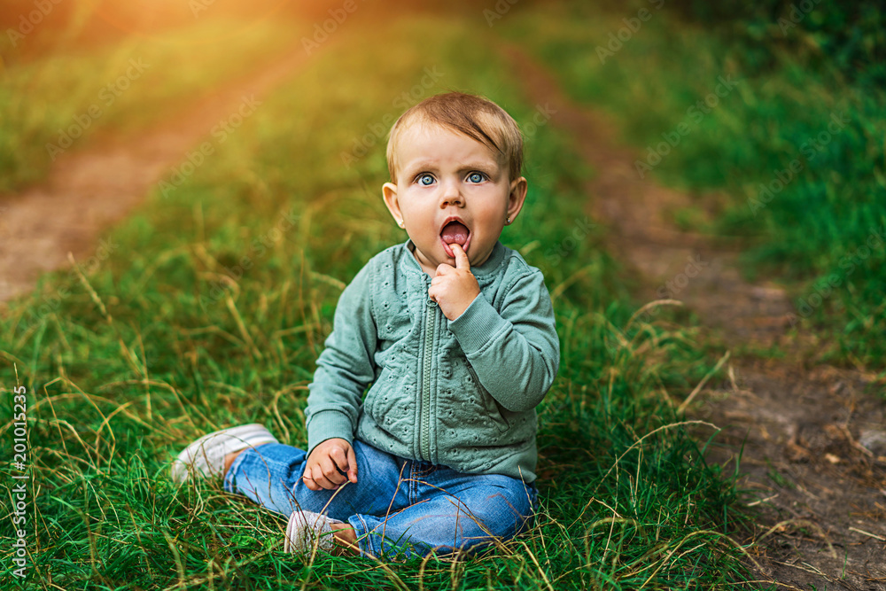 Fototapeta premium Pretty little baby girl playing outdoor