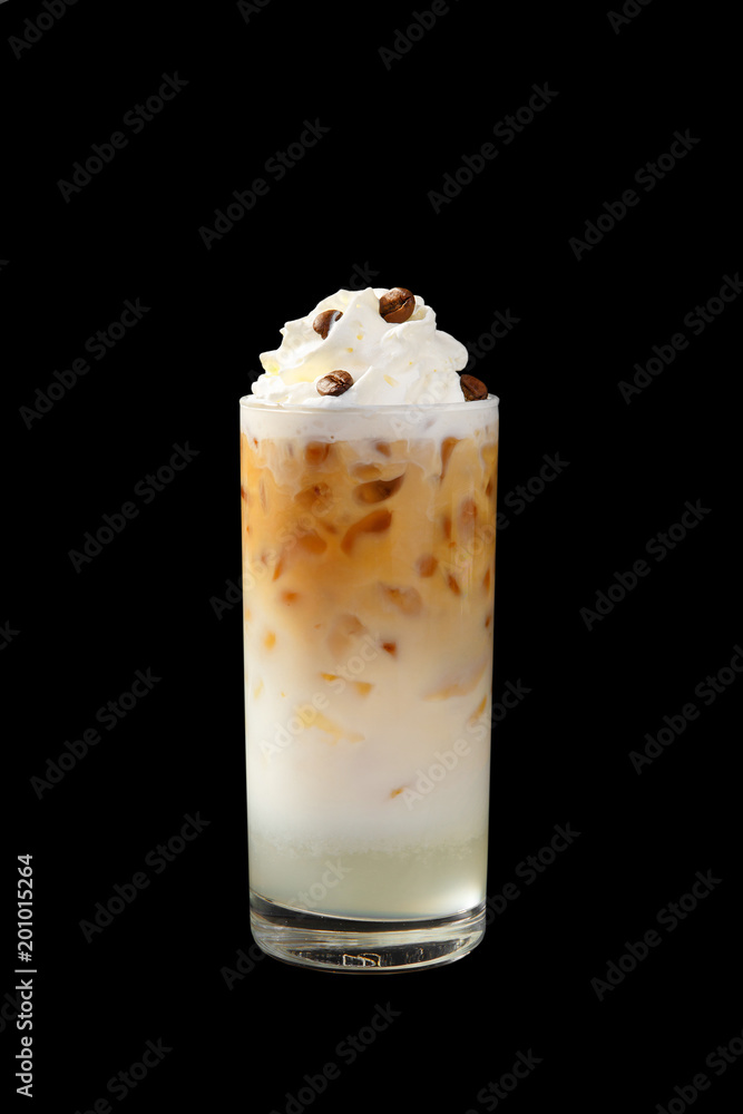 A multi-colored, two-layer opaque cocktail in a tall glass with chopped ice, whipped cream and coffee beans, with a taste of coffee, caramel, cream and straw. Side view. Isolated black background A multi-colored, two-layer opaque cocktail in a tall glass with chopped ice, whipped cream and coffee beans, with a taste of coffee, caramel, cream and straw. Side view. Isolated black background