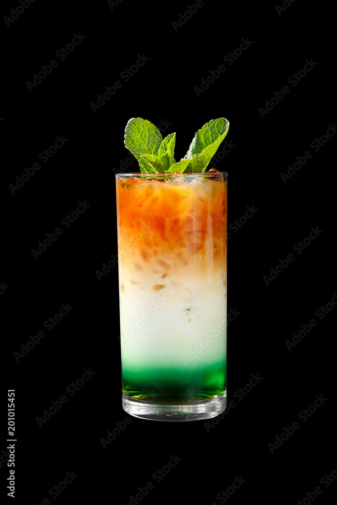 A multicolored, three-layered opaque cocktail in a tall glass with crushed ice and mint leaves and coffee beans, with the taste of menthol, coffee, caramel, cream. Side view. Isolated black background A multicolored, three-layered opaque cocktail in a tall glass with crushed ice and mint leaves and coffee beans, with the taste of menthol, coffee, caramel, cream. Side view. Isolated black background