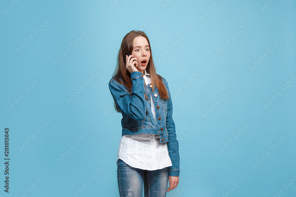 Beautiful teen girl looking suprised isolated on blue Beautiful teen girl looking suprised isolated on blue