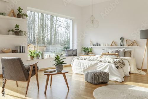 Spacious bedroom with big window interior