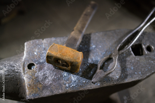 Hammer and forceps lie on the anvil