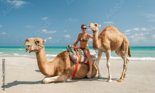 Pretty Young Woman Sitting on a Camel