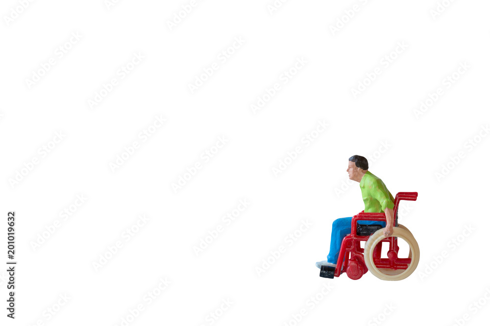 Miniature people Man in wheelchair  isolate on white background with clipping path
