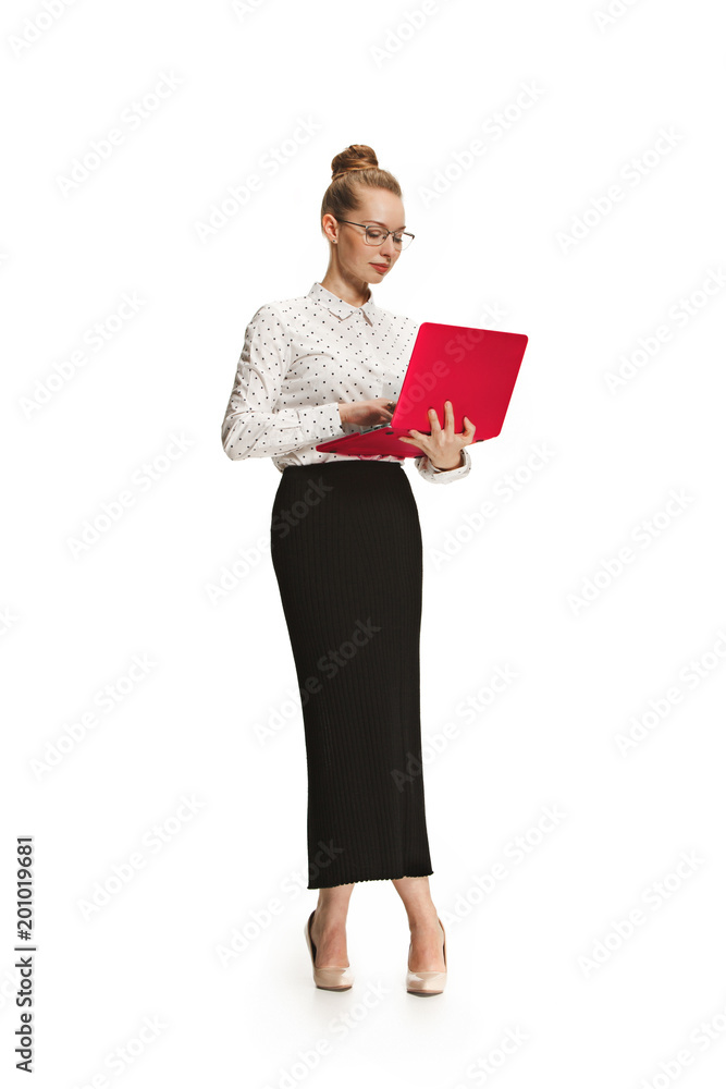 Full length portrait of a smiling female teacher holding a laptop isolated against white background Full length portrait of a smiling female teacher holding a laptop isolated against white background