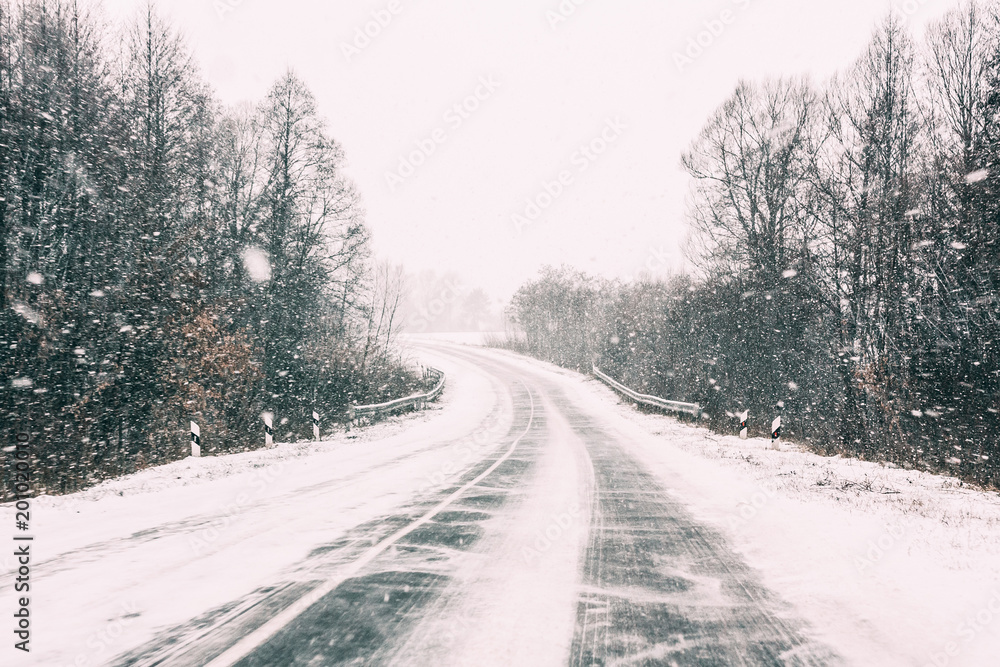 Snow-covered Open Road During A Winter Snowstorm. Adverse Weather Snow-covered Open Road During A Winter Snowstorm. Adverse Weather