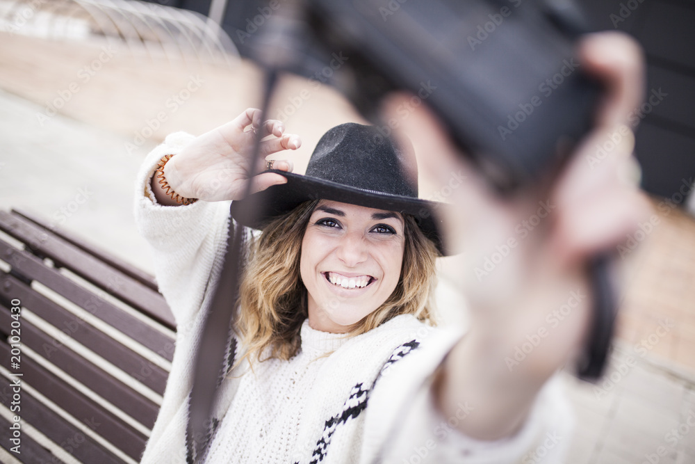 Woman taking selfie with camera on street Woman taking selfie with camera on street