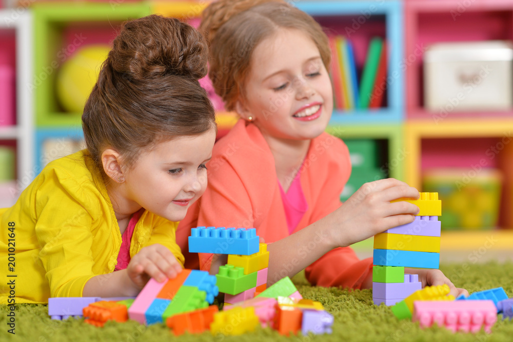 girls playing with colorful blocks girls playing with colorful blocks