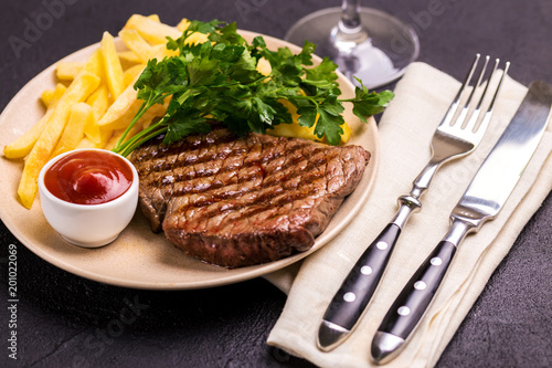 Fototapeta Naklejka Na Ścianę i Meble -  Grilled beef steak with tomatoes, french fries. Barbecue, bbq meat
