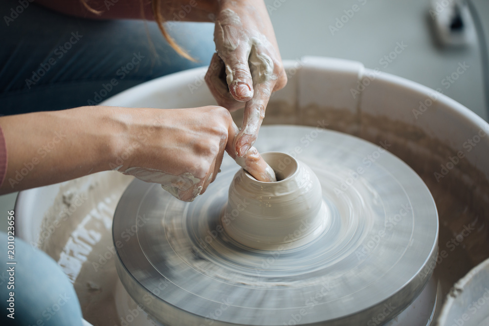 Handcrafted on a potter's wheel,Hands make clay from various items for home and sale in the store and at the exhibition, ceramic items are made in hand, the clay billet becomes a ceramic dish Handcrafted on a potter's wheel,Hands make clay from various items for home and sale in the store and at the exhibition, ceramic items are made in hand, the clay billet becomes a ceramic dish